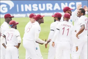  ??  ?? West Indies celebrate a wicket with fast bowler Shannon Gabriel (far right).