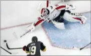  ?? JOHN LOCHER — THE ASSOCIATED PRESS ?? Washington Capitals goaltender Braden Holtby, right, stops a shot by Vegas Golden Knights right wing Reilly Smith during the third period in Game 2of the NHL hockey Stanley Cup Finals on Wednesday in Las Vegas.