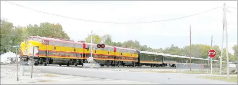  ?? Mike Eckels/Westside Eagle Observer ?? The Kansas City Southern Southern Belle executive train slows down as it enters the Main Street crossing in Gentry on Oct. 10, 2013. The Southern Belle stopped to pick up two passengers near the site where the Gentry depot once stood.