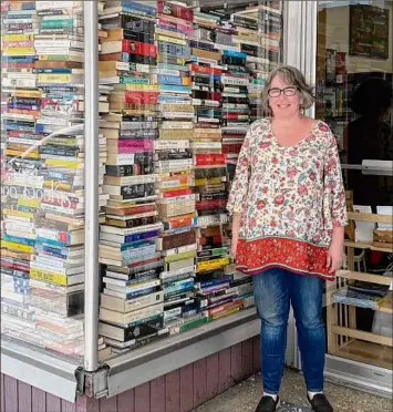  ?? Photo by Donna Liquori ?? Owner Jessica Dupont stands in front of Half Moon Books, her used bookstore in Kingston.