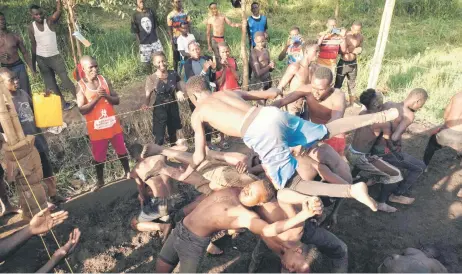  ?? — AFP photos ?? Members of Uganda’s Soft Ground Wrestling battle during a training session at their camp in Mukono.