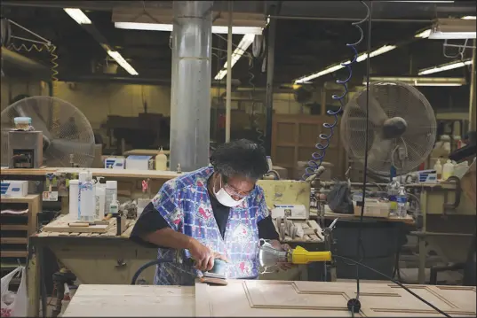  ?? PHOTOS BY TRAVIS DOVE / THE NEW YORK TIMES ?? Frances Wade sands a piece of wood on the production floor Oct. 28 at Century Furniture’s Case Goods in Hickory, N.C. The furniture capital of North Carolina is ground zero for inflation, labor shortages, hot demand and limited supply. It’s debating how to cope.