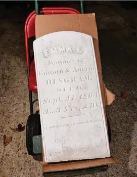  ?? ?? Ned Gerard/Hearst Connecticu­t Media
The headstone of Emma Bingham, who died in 1863 at the age of 3, currently in storage at the Milford Cemetery Associatio­n.