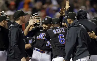  ?? Adam Hunger, The Associated Press ?? Mets pitcher Edwin Diaz (39) celebrates with teammates after completing a combined no-hitter against the Phillies on Friday in New York.