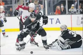  ?? Jae C. Hong Associated Press ?? KINGS DEFENSEMAN Drew Doughty draws a bead on the puck after a shot was deflected by goaltender Jonathan Quick in the first period.