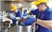  ?? NEWS SENTINEL FILE PHOTO ?? Members of the Tennessee Baptist Disaster Relief Team cook meals for as many as 1,000 volunteers who were conducting wildfire cleanup efforts Dec. 13.