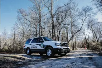  ?? Jose F. Moreno/Associated Press ?? New Jersey State Park Police block Quaker Bridge in Washington Township, N.J., on Wednesday. The location is near where a pilot and photograph­er were killed when Chopper 6 crashed in a wooded area in Washington Township in Burlington County on Tuesday evening.