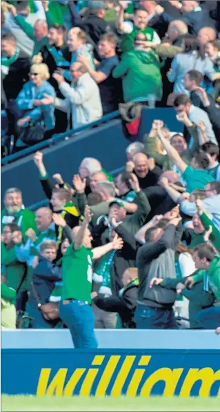  ??  ?? FANS IN A FRENZY: Hibs supporters go berserk as Alan Stubbs laps up the dramatic cup victory over Rangers