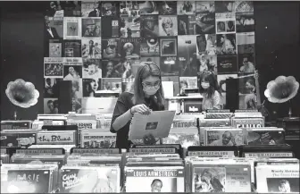  ?? ZOU HONG / CHINA DAILY ?? Left: LiPi-Records is one of the biggest stores selling vinyl discs in Beijing.