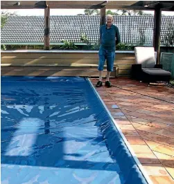  ?? PHOTO: SUPPLIED ?? Geoff Bonham with a swimming pool cover in Auckland.