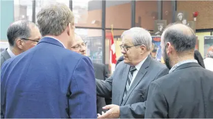  ?? DANIEL BROWN/THE GUARDIAN. ?? Cardigan MP Lawrence MacAulay socializes with employees of Veterans Affairs Canada at the Daniel J. MacDonald building in Charlottet­own on Friday.