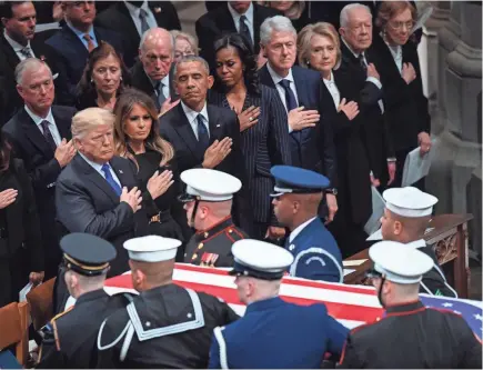  ?? JACK GRUBER/USA TODAY NETWORK ?? President Donald Trump and first lady Melania Trump, and former presidents and first ladies Barack and Michelle Obama, Bill and Hillary Clinton, and Jimmy and Rosalynn Carter, stand at the conclusion of the state funeral of former President George H.W. Bush at the Washington National Cathedral on Wednesday.