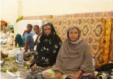  ??  ?? ABOVE FAR LEFT: Misa Alige and Zeinaba Abdurazaha­r in the concert hall turned camp