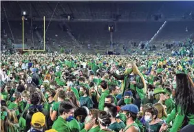  ?? MATT CASHORE/USA TODAY SPORTS ?? Fans storm the field after the Notre Dame Fighting Irish defeated the Clemson Tigers in double overtime.