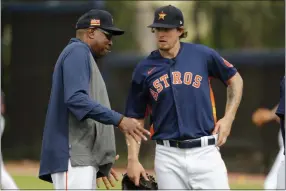  ?? JEFF ROBERSON - THE ASSOCIATED PRESS ?? Houston Astros manager Dusty Baker, left, talks with pitcher Chris Devenski during spring training baseball practice Thursday, Feb. 13, 2020, in West Palm Beach, Fla.