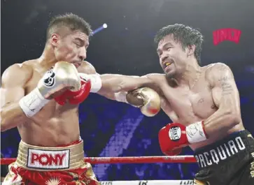  ?? AP ?? In this November 2016 photo, Manny Pacquiao (right) lands a right on Jessie Vargas during their WBO welterweig­ht championsh­ip match. After his unanimous-decision win in this fight, Pacquiao faces the undefeated Jeff Horn on Sunday.