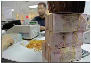  ?? (AP) ?? Vietnam’s dong currency is stacked at the Asia Commercial Bank in Hanoi in this file photo.