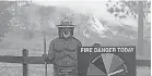  ?? SULLIVAN/ GETTY IMAGES JUSTIN ?? Fire burns near a Smokey the Bear fire warning sign as the Oak Fire burns through the area on Sunday near Jerseydale, Calif.