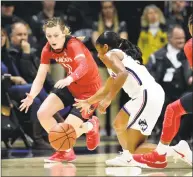  ?? Stephen Dunn / Associated Press ?? UConn’s Crystal Dangerfiel­d (5) steals the ball from Cincinnati’s Sam Rodgers (11) during Wednesday night’s 82-38 win in Storrs.