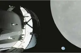  ?? NASA ?? A screengrab from NASA TV shows the capsule nearing the moon. Also in view, “our pale blue dot and its 8 billion human inhabitant­s,” said Mission Control’s commentato­r.