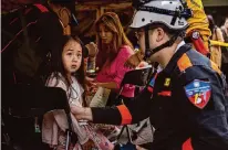  ?? Annabelle Chih/Getty Images ?? A child is given medical care Friday at a temporary rescue command post in Hualien, Taiwan, after Wednesday’s quake.