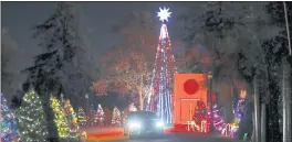  ?? NHAT V. MEYER — STAFF ARCHIVES ?? A car drives through a light display during a preview for Christmas in the Park — A DriveThru Holiday at History Park on Nov. 24, 2020. Walk-through plans are set for this year.