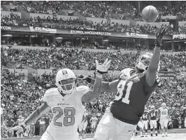  ?? ANDY LYONS/ GETTY IMAGES PHOTO ?? Dolphins cornerback Nolan Carroll covers the Colts’ Darius Heyward- Bey in Miami’s win on Sept. 15. “Every time I’m out there I feel like the ball is coming to me,” Carroll said.