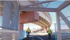  ?? DEAN HANSON/JOURNAL ?? Constructi­on workers walk the pedestrian path while work was underway at the Interstate 25 and Paseo del Norte project in 2014.