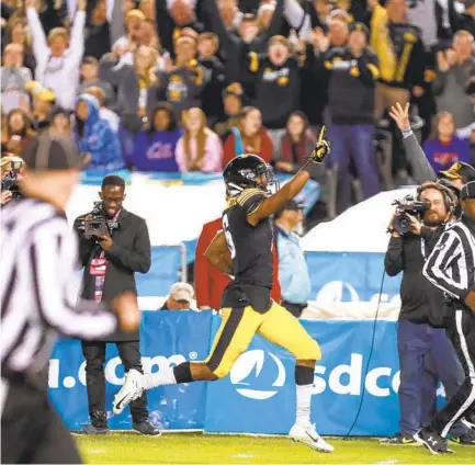  ?? HAYNE PALMOUR IV U-T ?? Iowa’s Ihmir Smith-marsette points to the sky as he runs for a touchdown on a 98-yard kickoff return in the second quarter.