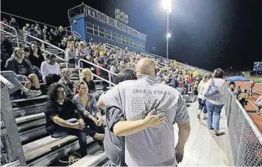  ?? [AP PHOTO] ?? Attendees make their way through the stands of a football stadium before a vigil for the First Baptist Church shooting victims Tuesday in La Vernia, Texas. A man opened fire inside the church in the small South Texas community on Sunday, killing more...