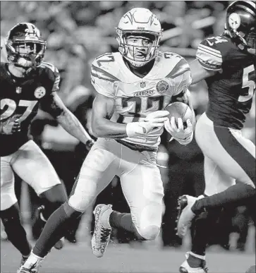  ?? Justin K. Aller Getty Images ?? THE CHARGERS’ Justin Jackson picks up yardage against Pittsburgh in L.A.’s 33-30 victory last week. Jackson and Austin Ekeler can expect more playing time because of the knee injury to Melvin Gordon.
