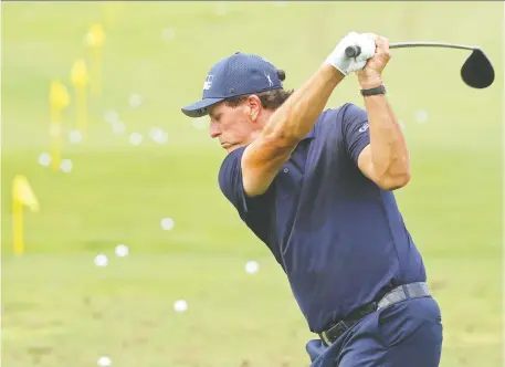  ?? ROB CARR/GETTY IMAGES ?? Phil Mickelson hits the driving range on Wednesday for some practice prior to the Masters this weekend. The veteran they call `Lefty' says the golfers competing this weekend don't care that the forecast calls for rain and lightning — they're just happy to be in Augusta, Ga.