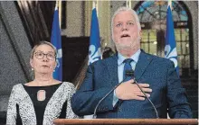  ?? JACQUES BOISSINOT THE CANADIAN PRESS ?? Quebec Premier Philippe Couillard touches his heart as he announces his resignatio­n Thursday at the legislatur­e in Quebec City.