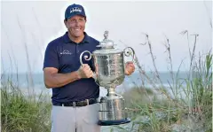  ?? AP Photo/David J. Phillip ?? ■ Phil Mickelson holds the Wanamaker Trophy after winning the PGA Championsh­ip on Sunday in Kiawah Island, South Carolina