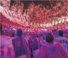  ?? DAVID GOLDMAN/ASSOCIATED PRESS ?? United States athletes watch fireworks during the closing ceremony. The U.S. won 46 gold medals at these Games.