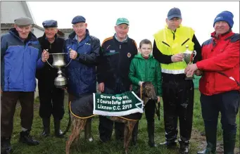  ??  ?? William O’Connor and Con O’Keeffe presenting the cup to Joe McCarthy and winning connection­s after Joe’s dog, Listowel Danger, won the Dew Drop Inn cup at Lixnaw coursing on Sunday.