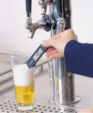  ??  ?? A CNM student measures the temperatur­e of a recently poured beer in class. CNM’s fledgling brewing program was recently named the second-best brewing school in North America at the U.S. Open College Beer Championsh­ip.