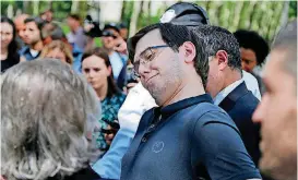  ?? [AP PHOTOS] ?? Martin Shkreli makes a face Friday as his attorney Benjamin Brafman discusses his client’s reputation while talking to reporters after leaving federal court in New York. The former pharmaceut­ical CEO has been convicted on federal charges he deceived...