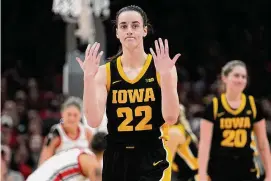  ?? ?? Iowa guard Caitlin Clark gestures in the first half against Ohio State on Sunday in Columbus, Ohio. Clark was knocked down, but not injured by a court stormer from Ohio State.