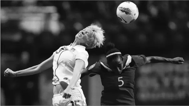  ?? Ben Nelms,reuters ?? Megan Rapinoe of the United States, left, and Canada’s Robyn Gayle battle for the ball during their final CONCACAF women’s Olympic qualifying tournament
soccer match in Vancouver on Sunday night. The Americans won 4-0.