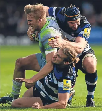  ??  ?? Newcastle’s Chris Harris is tackled by Baths’s Max Clark and Paul Grant