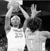  ?? RYAN M. KELLY/GETTY ?? Mamadi Diakite shoots over North Carolina’s Leaky Black during the second half of Virginia’s victory Sunday.