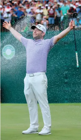  ?? WARREN LITTLE/GETTY IMAGES ?? Branden Grace of South Africa is sprayed with champagne after winning the Nedbank Golf Challenge in Sun City