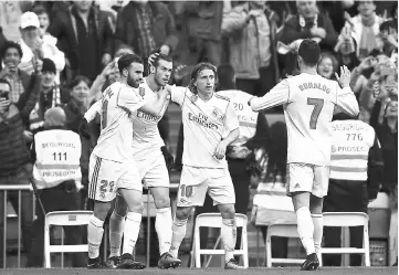  ??  ?? Real Madrid’s Welsh forward Gareth Bale (second left) celebrates with Real Madrid’s forward Borja Mayoral (left), Real Madrid’s Croatian midfielder Luka Modric (second right) and Real Madrid’s Portuguese forward Cristiano Ronaldo after scoring during...