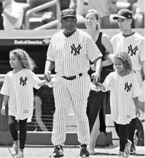  ?? SETH WENIG/ASSOCIATED PRESS ?? Tim Raines and his family participat­e in Old-Timers’ Day at Yankee Stadium last month. Raines was with the Yankees for three seasons, 1996-98.