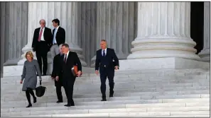  ?? AP/JACQUELYN MARTIN ?? Petitioner­s Susan Jeffers (left) and Andrew Cilek (right) leave the Supreme Court with members of their legal team Wednesday in Washington, where they’re challengin­g a Minnesota law restrictin­g what voters can wear at the polls.