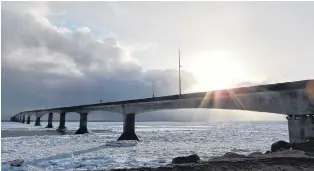  ??  ?? Odarka Farrell watched as convective clouds delivered pockets of wind- driven snow across the Northumber­land Strait. There was just enough sun to backlight the magnificen­t Confederat­ion Bridge that links Prince Edward Island and New Brunswick.