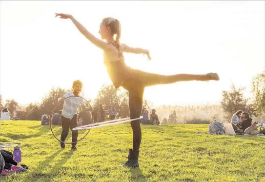  ?? Calvin B. Alagot Los Angeles Times ?? BARNSDALL ART PARK is a relaxing spot in East Hollywood. You can try to hula hoop like Kimberly Hamilton here, lounge on the grass or enjoy a see-it-all walk.