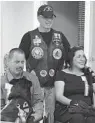  ??  ?? Paul Bertam, standing, volunteers with Guardian Angels Medical Service Dogs.