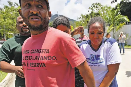  ?? Carl De Souza / AFP / Getty Images ?? Grieving relatives arrive at the Flamengo soccer club training center in a western neighborho­od of Rio de Janeiro.